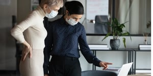 focused-two-women-in-medical-protective-masks-working-in-office-picture-id1216915205 (1)