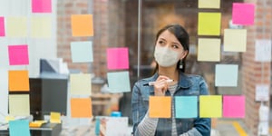 woman-brainstorming-at-the-office-while-wearing-a-facemask-picture-id1287294863 (1)